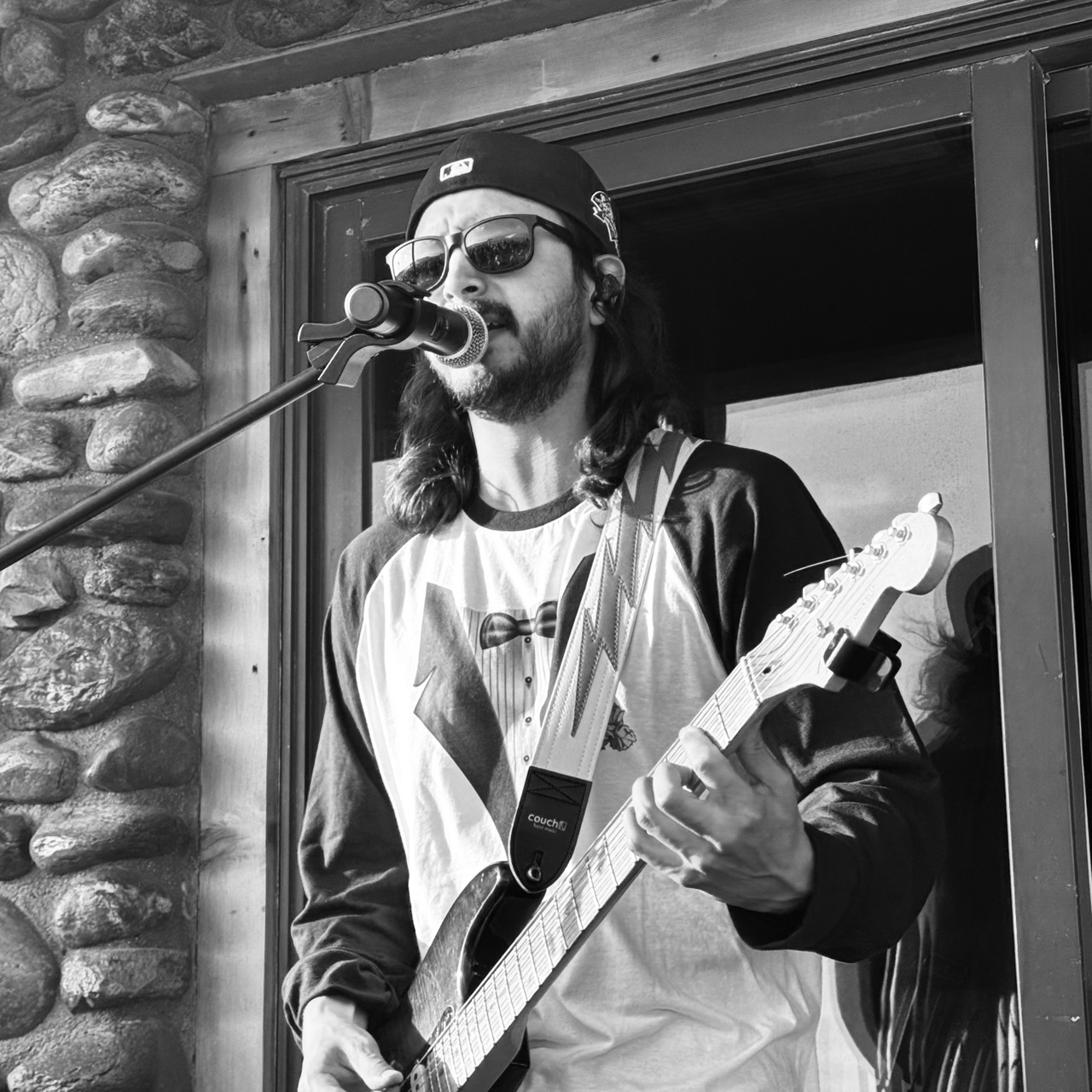 Petey singing and playing guitar outdoors