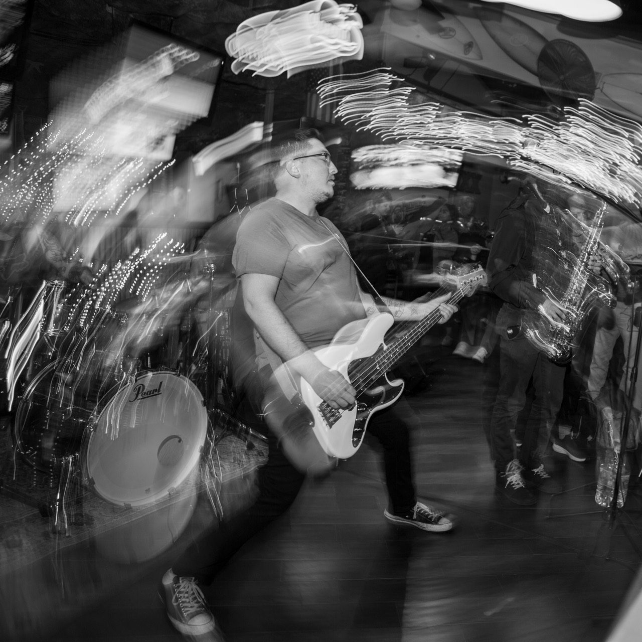 Zachary playing bass in a motion-filled live performance